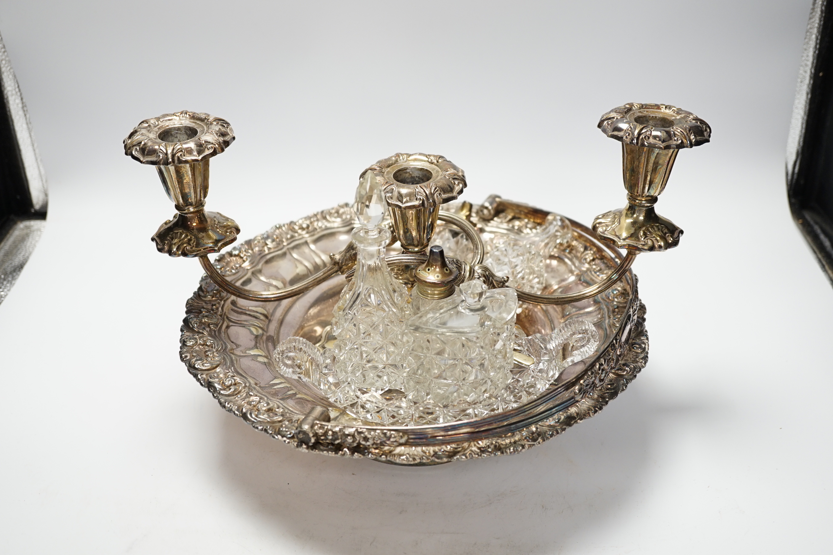 A pair of plated tureens, an oval tray, a basket, three branch candelabra, etc.